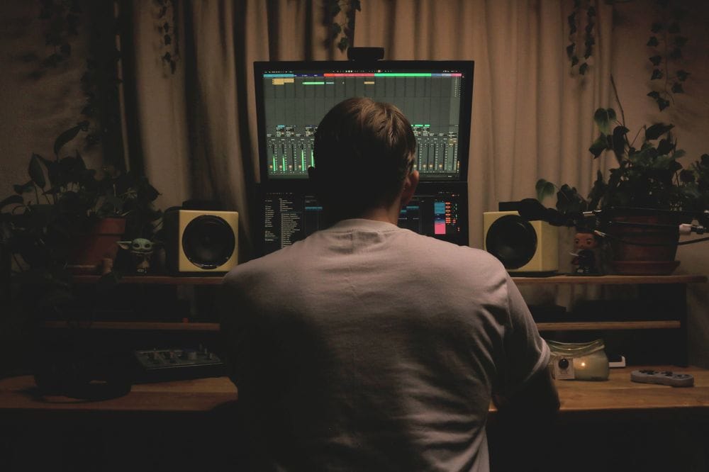 Jamey sitting at his production desk at home.